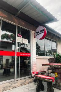 a fast food restaurant with a bench in front of it at Langkawi Tok Jah Guest House Pantai Cenang in Pantai Cenang