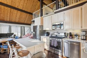 eine Küche mit weißen Schränken und einem Tisch im Zimmer in der Unterkunft Warm and Cozy Mountain and Lake View Haven cottage in Kelseyville + 23 Fotos