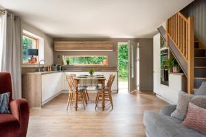 a kitchen and dining room with a table and chairs at Sunnybrook - A luxurious Carbon Neutral House close to beach, Shaldon in Shaldon +50 photos