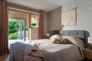 a bedroom with a large bed and a window at Sunnybrook - A luxurious Carbon Neutral House close to beach, Shaldon in Shaldon
