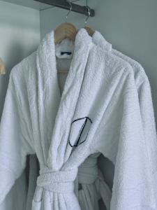 a white towel hanging on a towel rack at Sand House Doñana - Free beach club access to Kai Club in Patalavaca