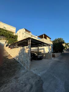 a car parked in a parking lot next to a house at Apartment Block Two in Šibenik