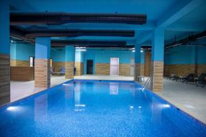 a large swimming pool in a building with blue ceilings at Blue Vista Houses & Spa in Esenyurt