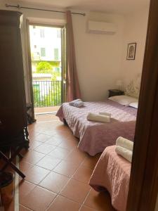 sypialnia z dwoma łóżkami i dużym oknem w obiekcie Apartment ninnananna we Florencji