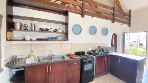 a kitchen with a sink and a stove at Wide Horizons Mountain Retreat in Malkerns