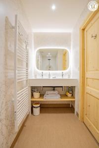 a bathroom with a sink and a mirror at Le Domaine de la Source in Chauffailles