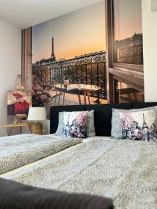a bedroom with a poster of the eiffel tower at Casa Romana Aqua Apartman in Siófok