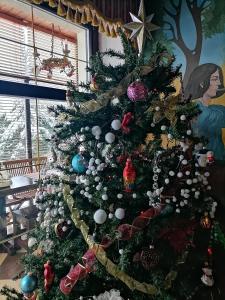 a christmas tree with ornaments on it at Chalet Zolota Pidkova in Slavske +210 photos