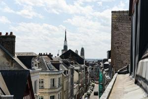 a view of a city from a balcony with buildings at Gare - Le grenier de Beauvoisine in Rouen