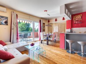 a living room with a couch and a table at Holiday Home Morski dragulj by Interhome in Vodice