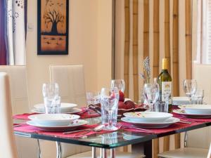 a table with plates and glasses and a bottle of wine at Holiday Home Morski dragulj by Interhome in Vodice +41 photos