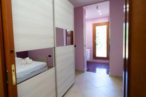 a room with a bed and a sliding glass door at Maccuro Luxury Apartment in Vibo Valentia Marina +2 photos
