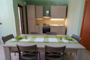 a kitchen with a table and chairs and a kitchen with at Maccuro Luxury Apartment in Vibo Valentia Marina