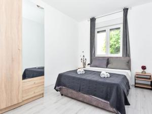 a bedroom with a large bed and a mirror at Holiday Home Jurica by Interhome in Vrsi