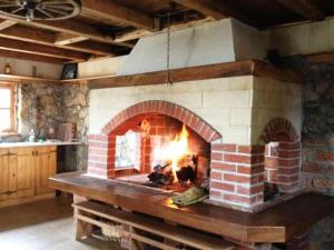 a brick oven with a fire in it at Kuća za odmor Vidikovac in Rumboci