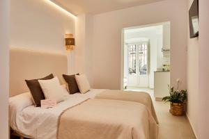 a bedroom with two beds in a room at LUPERCAS in Mérida