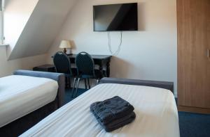 Postel nebo postele na pokoji v ubytování Hotel de Harmonie