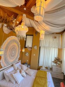 a bedroom with a large bed with chandeliers at Pino - Villa, Casa, Cucina е Terrazza in Albena