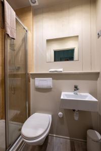 a bathroom with a toilet and a sink and a shower at Vert Lodge Chamonix in Chamonix-Mont-Blanc