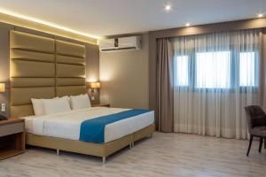 Un ou plusieurs lits dans un hébergement de l'établissement Tryp by Wyndham Asuncion