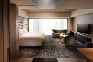 a hotel room with a bed and a couch at Hilton Kyoto in Kyoto