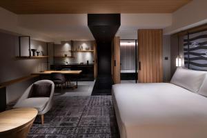 a bedroom with a bed and a dining room at Hilton Kyoto in Kyoto