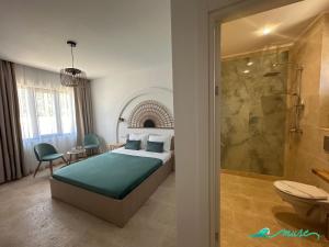 a bedroom with a bed and a bathroom with a shower at Muse 2Mai in 2 Mai +36 photos