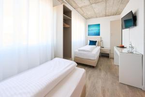 Postel nebo postele na pokoji v ubytování Aabach Hotel