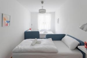 a room with a couch and a bed with a window at Studio Bauhaus am Hauptbahnhof in Dessau