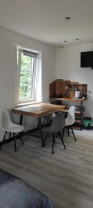 a dining room with a wooden table and chairs at Beskidzka Guest House in Szczyrk