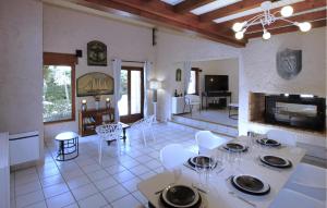 a kitchen and living room with a table and chairs at Awesome Home In Meyzieu in Meyzieu