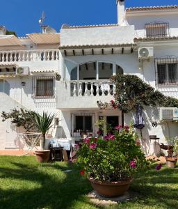 a white house with flowers in front of it at Tranquil setting in Moraira