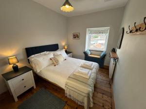 a bedroom with a white bed and a window at Totterdown House with Views & Garden in Bristol