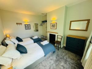 a bedroom with two beds and a fireplace at Totterdown House with Views & Garden in Bristol