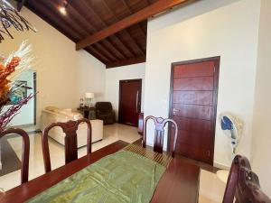 a room with a wooden door and a living room at Casa Alto da Boa Vista in Serra Negra +26 photos
