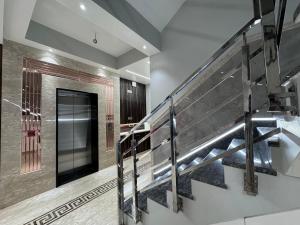 a staircase with a metal railing in a building at Hotel Jia International in Patna