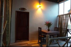 a dining room with a table and chairs and a door at Villa Sala Vanna in Savannakhet