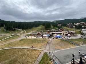 an aerial view of a village with people on a field at Très beau studio rénové Puy Saint Vincent 1600 in Puy-Saint-Vincent +3 photos