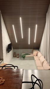 a living room with a couch and a table and lights at Chalés Piribless-Ikigai in Pirenópolis