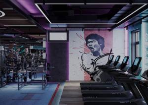 a gym with a mural of a man on the wall at MIRZO HOTEL in Tashkent