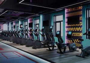 a gym with rows of tread machines in a row at MIRZO HOTEL in Tashkent