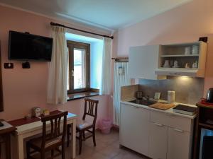 a kitchen with a sink and a table and chairs at Villa Celeste in Rocca Pia +24 photos