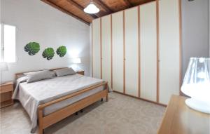 a bedroom with a bed with green plants on the wall at Gorgeous Home In Vittoria With Wifi in Vittoria