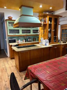 a kitchen with wooden cabinets and a stove top oven at Valletta cozy room in Valletta