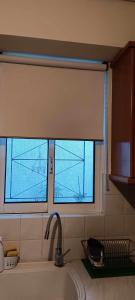 a window in a kitchen with a sink at Athenian Asty Guesthouse in Athens +36 photos