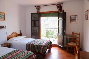 Postel nebo postele na pokoji v ubytování Hotel los Bérchules