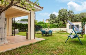 a garden with a slide and a table and chairs at Beautiful Home In Bollullos De La Mitaci in Bollullos de la Mitación +11 photos