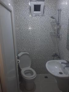 a bathroom with a toilet and a sink at Apartment- GURO in Batumi +1 photo