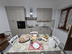 a kitchen with a table with a table cloth on it at Nonna's house in Iglesias