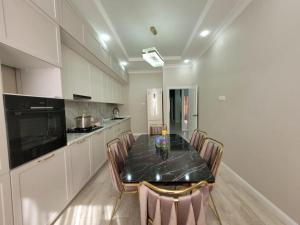 a kitchen with a table and chairs in a room at квартира in Aktau
